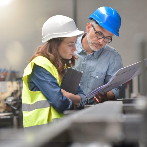 Metal industry manager and engineer meeting in factory